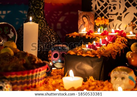 Colorful skull on colorful traditional Day of the Dead "ofrenda" Royalty-Free Stock Photo #1850533381