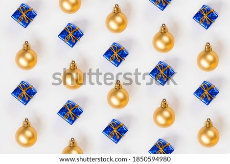 Golden Christmas balls and blue gifts. New year. Flat lay