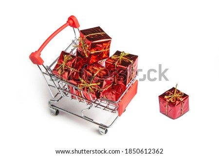 Gifts in the buyer's basket. Full shopping cart.  The concept of gifts and purchases before the New Year. White isolated background. 