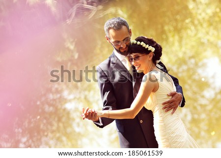Bride and groom near lake surrounded by nature