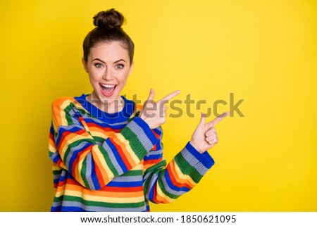 Photo of young excited girl show point fingers empty space happy smile advert choose recommend isolated over yellow color background Royalty-Free Stock Photo #1850621095