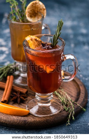 Winter drink with oranges and cloves, traditional mulled wine on a wooden tray