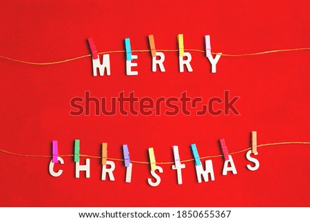 Merry Christmas greeting message on red background, Christmas composition with decorations winter, new year concept. Flat lay, top view, copy space