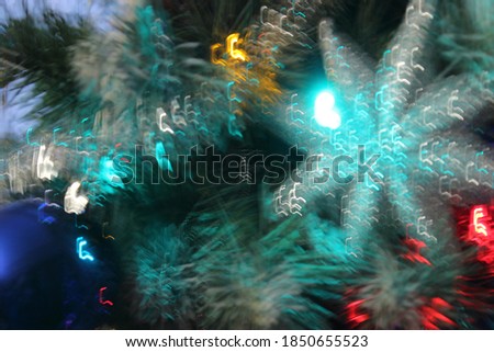 Green star and other Christmas tree toys in blur on Christmas tree for background