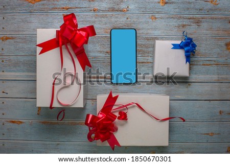 merry christmas background with cell phone and gifts christmas mockup