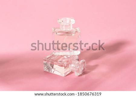 Glass perfume bottles in bright sunlight with harsh shadows.