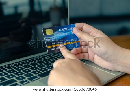 Woman holding credit card on laptop. shopping online payment concept.