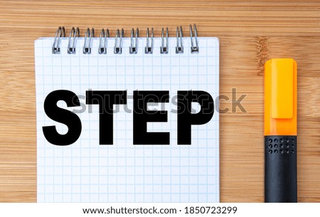 Business concept. On the wooden table is a marker and a notebook with the inscription step. Business Process Management