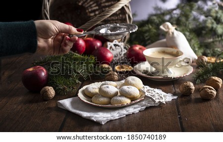 christmas sweets on vintage plate with apples and walnuts