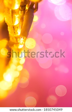 Out-of-focus Christmas garlands in the form of pink-orange bokeh