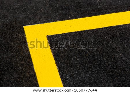 yellow markings angle of the new highway with tarmac road surface close up asphalt texture of bitumen roadside route, nobody. 