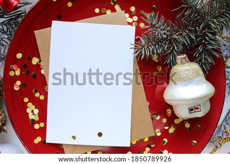 christmas postcard mockup. Christmas composition of fir branches, cones and Christmas tree decorations on a red background.