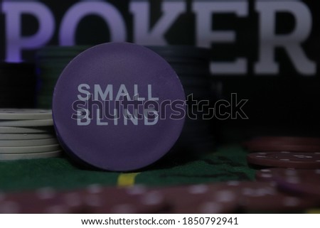 Poker game, small blind chip, with red chips around it and the word "poker" highlighted in the background.