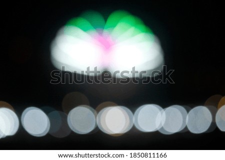 Blurred colorful bokeh lights in the night. Backgrounds for graphic design, Christmas holidays, New Year's festivals or celebrations.