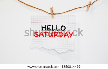 The Notepad with the text Hello Saturday is on colored paper with color pencils. Concept photo