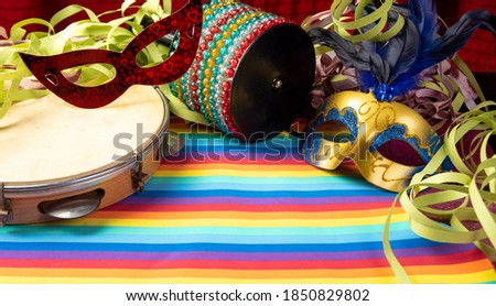 Masks, streamers, musical instruments of the Brazilian carnival, on a colorful surface, Selective focus.