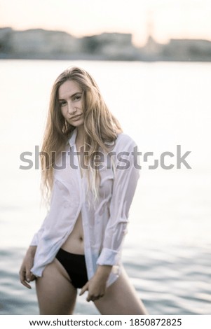 woman in a white shirt and black panties in the river 