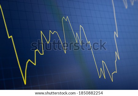 Tilted Yellow Stock Chart or Forex Chart and Table Line on Black Background on Unstable Trend. Technical Analysis Graph for Trading in Market Royalty-Free Stock Photo #1850882254