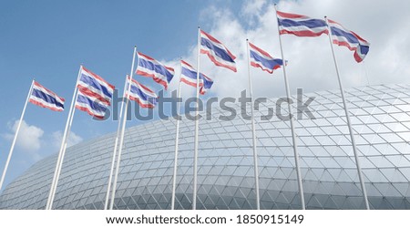 The national flags of Thailand are waving. Background of the aluminum mesh roofs and the sky