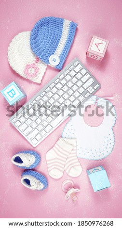 Baby nursery clothing mom bloggers desktop workspace with pink and blue accessories on stylish pink textured background. Top view blog hero header creative composition flat lay.