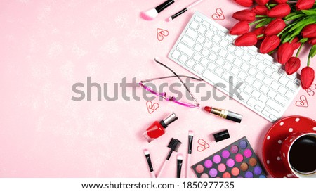 Beauty makeup shopping feminine pink red theme bloggers desktop workspace with keyboard and accessories on stylish pink textured background. Top view blog hero header creative composition flat lay.