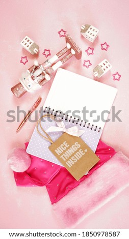 Christmas holiday feminine pink theme desktop workspace with lady santa hat and accessories on stylish pink textured background. Top view blog hero header creative composition flat lay. Copy space.