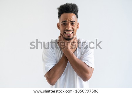Studio head shot young african american guy touching neck, suffering from strong throat sore, angina.