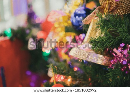 Decorated Christmas bell baubles on fir tree New Year holidays background