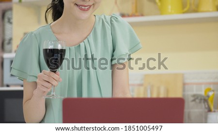 
Young woman having an online drinking party