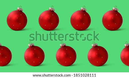 Seamless pattern red Christmas balls, decorations for the Christmas tree, isolated on a green background. Banner. Packaging with New Year's paper.