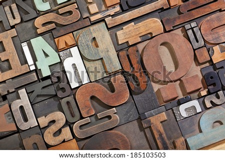 Vintage letterpress type background. Antique letterpress printing blocks, random collection of different sizes and styles, tilted view