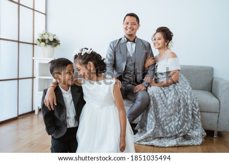 Portrait of a happy family with modern clothes. Family photo concept in the living room