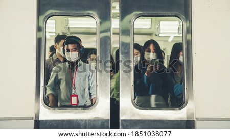 Crowd of people wearing face mask on a crowded public subway train travel . Coronavirus disease or COVID 19 pandemic outbreak and urban lifestyle problem in rush hour concept . Royalty-Free Stock Photo #1851038077