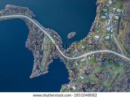 Aerial view on a winding s-shaped road between two lakes and a village in the Republic of Karelia
