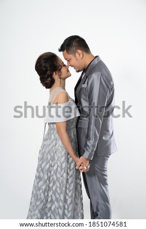 Portrait men and women wearing wedding dresses and suits. Couple photo concept isolated on white