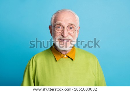Photo of pensioner grandpa beaming smile look camera wear glasses green pullover isolated blue color background Royalty-Free Stock Photo #1851083032