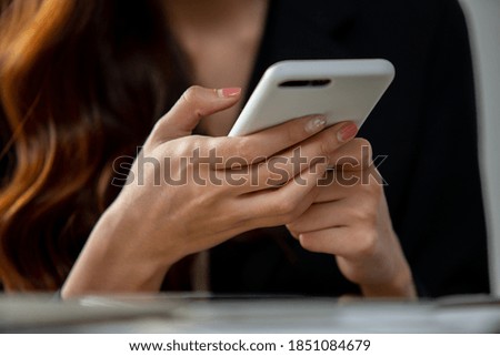 Close up of women's hands holding cell telephone with blank copy space scree for your advertising text message or promotional content,watching video on mobile phone during 