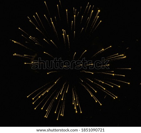 Real golden spray of fireworks in holiday night black sky