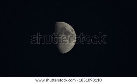 A half moon in the night sky