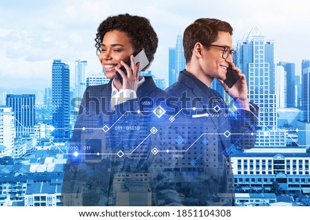 Businessman and businesswoman as a part of corporate team processing conference call to achieve tremendous growth in commerce using new technological approaches. Tech hologram icons over Kuala Lumpur