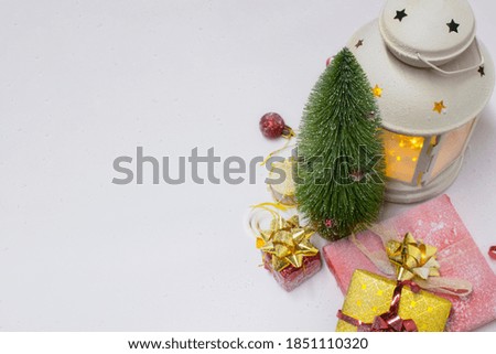 Christmas tree and decorations with Festive glowing lamp, gifts and bright bows on a white background. Christmas and New Year composition