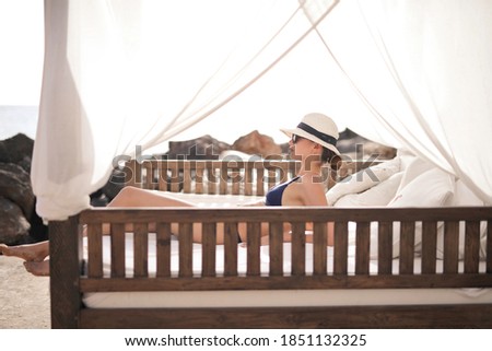 
young woman on a bed at the beach