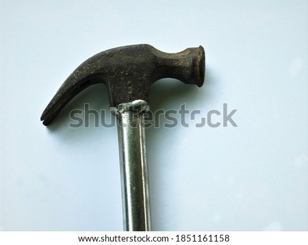 Closeup steel hammer head and iron handle isolated on white background.