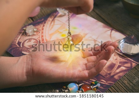 Palm reading, characterization and foretelling the future through the study of the palm with pendulum Royalty-Free Stock Photo #1851180145