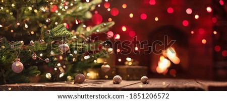 Christmas Tree With Decorations Near A Fireplace with Lights Royalty-Free Stock Photo #1851206572