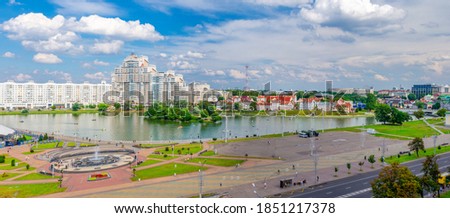 Aerial panoramic view of Minsk city historical centre Nemiga with Svislach Svislac river embankment and Traeckaje Suburb Trinity Hill, blue sky white clouds in sunny summer day, Republic of Belarus Royalty-Free Stock Photo #1851217378