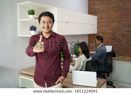 Portrait of a happy manager man. Show trust, showing thumbs