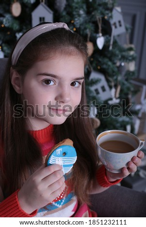 A girl of nine years old with long blond hair on the New Year and Christmas holiday