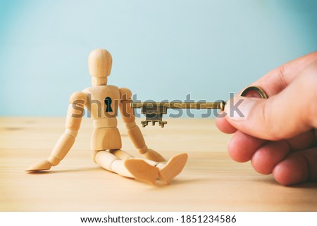 concept of unlock your potential. person hand with key to dicover new talents and achievements Royalty-Free Stock Photo #1851234586