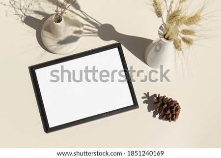 Empty black picture frame white background with natural props